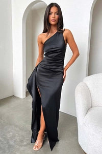 Detail of elegant black one-shoulder satin maxi dress with side slit and ruffled hemline