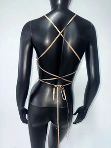 Detail of silver sequin chainmail top with intricate backless criss-cross lace-up design