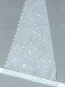 Macro shot of high-density rhinestone mesh fabric with sparkling crystal detail