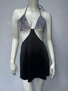 Detailed view of silver rhinestones and cutout design on a sexy black halter dress