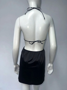 Back view of a black halter top and satin mini skirt set with delicate bow tie details