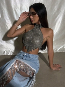 Detailansicht des glitzernden Neckholder-Tops mit asymmetrischem Saum und Metallic-Finish