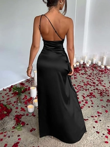 Elegant black satin backless dress with side slit in a romantic candlelit setting