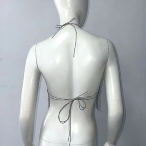 Detail view of silver fringe halter top with back tie closure for parties and festivals