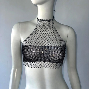 Close-up of black fishnet crop top with sparkling rhinestones and halter neck tie