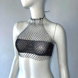 Detailed close-up of a black fishnet halter top with sparkling rhinestones and beads