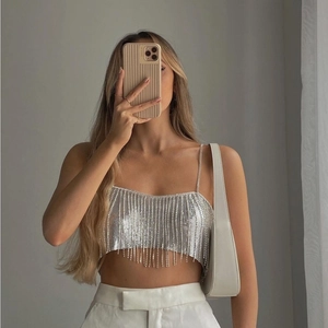 Detailed view of silver sequin fringe crop top with metallic tassel shine and chain straps