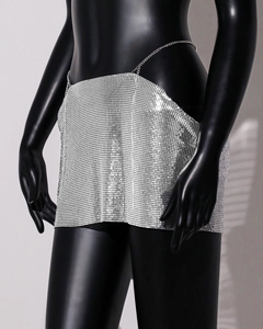 Detail of silver metallic sequin mesh mini skirt with metal ring link construction