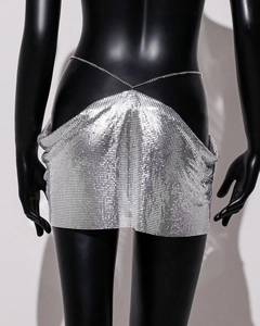 Detailed shot of silver metal sequins and chain belt on an irregular mini skirt