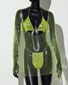 Close-up of neon yellow rhinestone fishnet dress set with sparkling crystals and mesh fabric