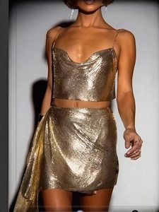 Sexy golden metal mesh two-piece set featuring a deep V-neck crop top and mini skirt