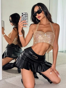 Haut licou à paillettes dorées sexy avec mini-jupe en cuir noir pour un look tendance