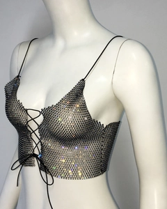 Detail of black mesh camisole featuring sparkling rhinestones and lace-up front straps
