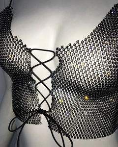 Close-up of black mesh halter top with sparkling rhinestones and lace-up detail