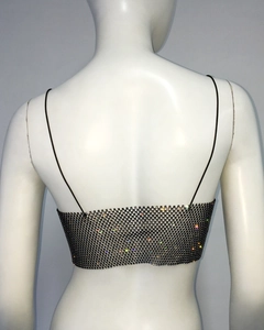 Macro detail of black fishnet camisole back featuring shimmering rhinestones and thin straps