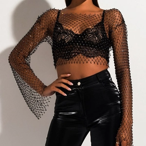 Close-up of black mesh top with sparkling rhinestones and elegant flare sleeve details