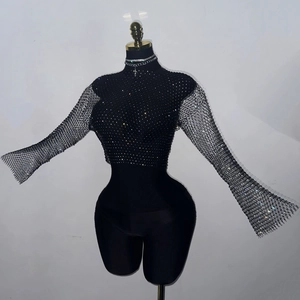 Detail of black rhinestone mesh crop top with bell sleeves and shimmering crystals