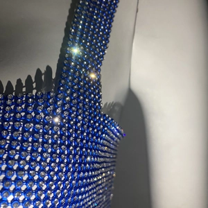 Macro view of blue metal mesh top with sparkling rhinestones showing fine craft details