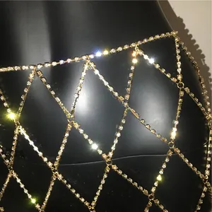 Close-up of golden mesh body chain with sparkling rhinestones for luxury party styling