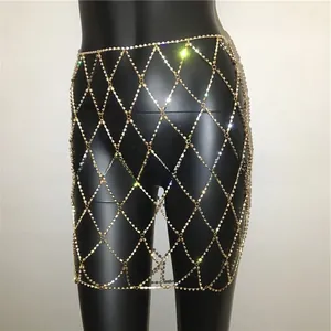 Detailed view of sexy gold rhinestone mesh body chain skirt on black mannequin