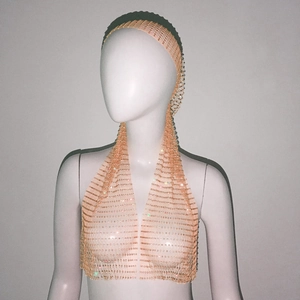 Detailed close-up of light gold mesh headpiece featuring sparkling rhinestones on a mannequin