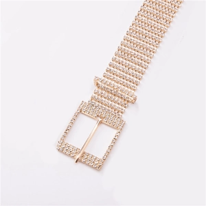 Détail macro d'une ceinture dorée scintillante avec 10 rangées de strass brillants et boucle