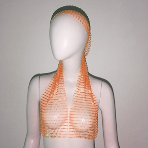 Detailed close-up of pink fishnet wrap top and matching headband with sparkling rhinestones
