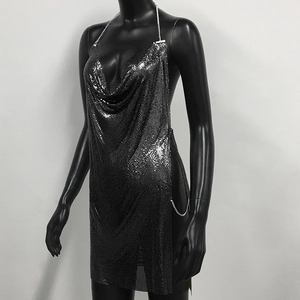 Detail of silver chainmail mini dress showing the metallic sequins and side chain link