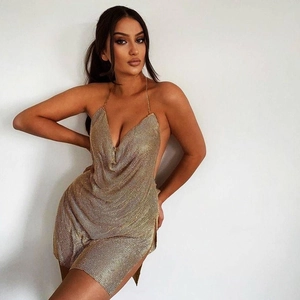Detailed view of the backless golden metallic mesh party dress with halter neckline