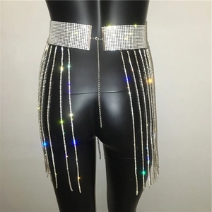 Detailed close-up of sparkling silver rhinestone fringe on a sexy beach mini skirt waist chain