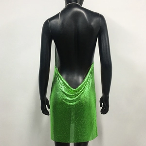 Detail of green metallic sequin backless dress with deep V-cut and mesh texture