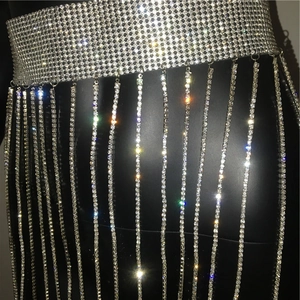 Detailed view of silver rhinestone fringe skirt body chain for party wear on black model