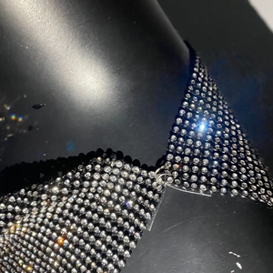 Gros plan du haut de bikini étincelant en strass avec bonnets triangles et lien en métal