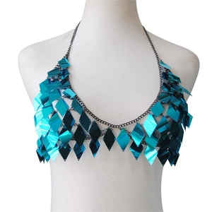 Detail of bright blue sequin body chain with diamond-shaped scales on a white mannequin