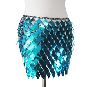 Detail view of turquoise sequin mini skirt with diamond-shaped metallic mirror plates