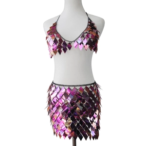 Detail of iridescent sequin two-piece set with diamond-shaped metal scales and chain links