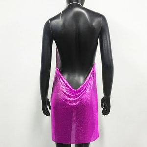 Detail of fuchsia metal sequin dress featuring open back design and silver chain straps
