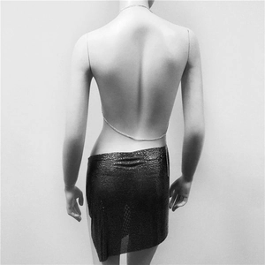 Close-up of sexy metallic sequin skirt and back body chains for women party wear