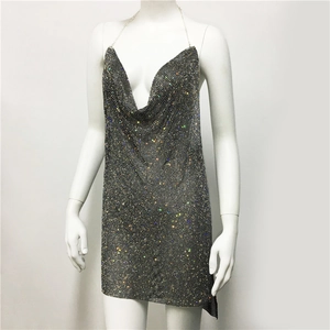 Close-up of deep V-neckline on metal mesh dress with colorful sparkling rhinestones