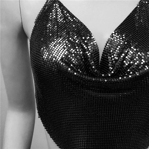 Detail view of a black metallic sequin halter crop top with a cowl neck and shimmering texture