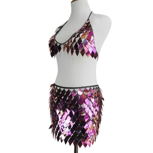 Detailed view of iridescent sequin crop top and mini skirt set with metallic chain links