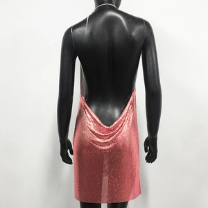 Close-up of rose gold sequin mesh fabric and backless design on a party dress