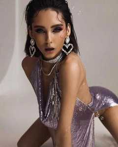 Detail of purple sequin halter dress with heart crystal earrings and layered choker