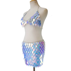 Detail of laser diamond sequins and metal chains on a two-piece blue party skirt set
