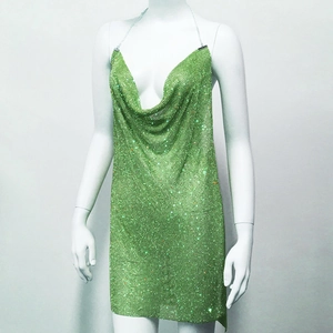 Close-up of green rhinestone metal mesh dress featuring a deep V-neck and halter style
