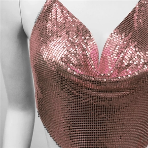 Detail of rose gold metal sequin chainmail top with deep V-neck and thin straps