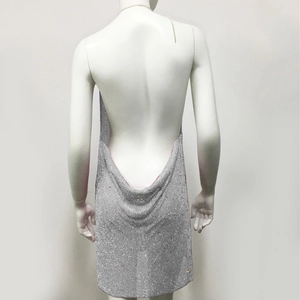 Close-up of sparkling silver rhinestone backless mini dress with metallic mesh texture