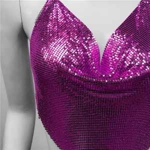 Detailed macro view of vibrant purple sequin metal mesh top with shiny metallic textures