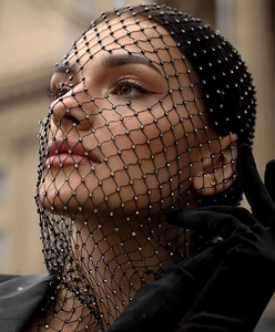 Close-up of black mesh veil headpiece with sparkling rhinestones for party fashion