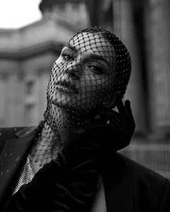 Macro detail of black mesh rhinestone headscarf veil showing sparkling crystal texture